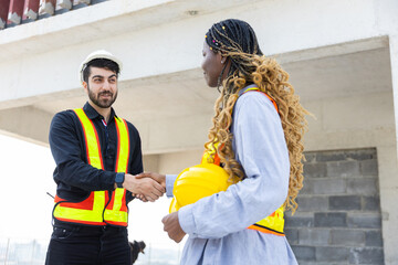Engineering and foreman shaking hands on construction site and Agree. partnership and connection....