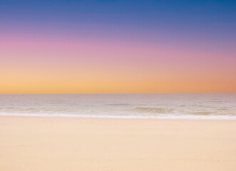Sunset scene with wave water in the Tropical summer beach with  sandy beach background