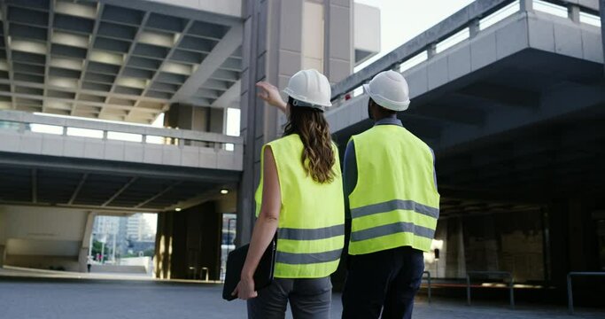 Civil engineering, people and bridge or outdoor building at construction site, urban development or city infrastructure. Back of project manager, industrial team or architecture contractor inspection