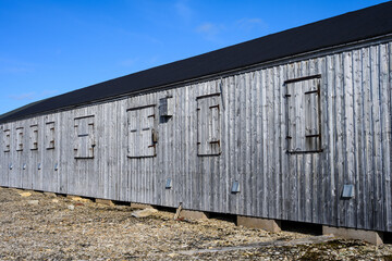 Fototapeta premium Weathered wood buildings of research station at Kinnvika, Murchison Fjord, Hinlopen Straight on Svalbard in the Arctic 