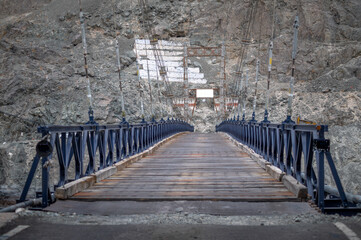 The suspension bridge crossing the river in Ladakh, India. Rustic Metal Bridge Image. Bridge...