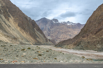 Scenic view of Himalayas and Ladakh ranges. Beautiful barren hills in Ladakh with dramatic clouds in the background.  View from the road from Nubra Valley to Turuk. 