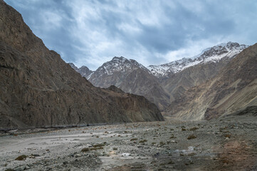 Scenic view of Himalayas and Ladakh ranges. Beautiful barren hills in Ladakh with dramatic clouds in the background.  View from the road from Nubra Valley to Turuk. 