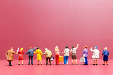 Miniature people , A group of women stand together On a pink backdrop, International Women's Day...
