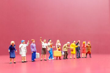 Miniature people , A group of women stand together On a pink backdrop, International Women's Day concept