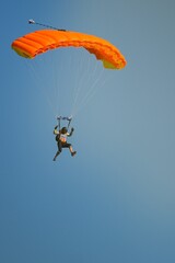 Two isolated skydiver with bright colorful parachute  in the air during sunny day, Klatovy, Czechia