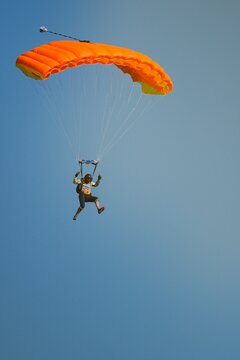 Two isolated skydiver with bright colorful parachute  in the air during sunny day, Klatovy, Czechia