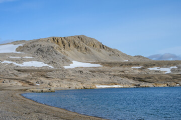 Rocky beach at Kinnvika, Murchison Fjord, Hinlopen Straight on Svalbard in the Arctic, as a nature background
