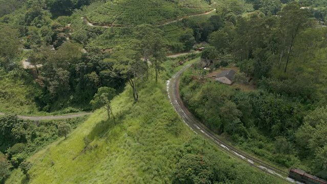 Aerial Drone Shot of Train Coming Up Demodara Loop and Stopping at Demodara Train Station in Sri Lanka