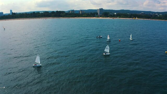 Aerial view of Optimist dinghy boats sailing on the baltic Sea at sunny vacation day