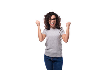 young cheerful pretty curly woman dressed in gray t-shirt with printable mockup