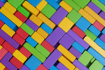 Colorful background of wooden blocks. A Spectrum of multi colored wooden blocks aligned. Background or cover for something creative or diverse.