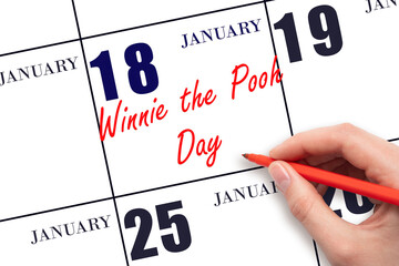 January 18. Hand writing text Winnie the Pooh Day on calendar date. Save the date.