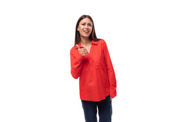 young pretty brunette office worker woman dressed in a red loose shirt on a white background