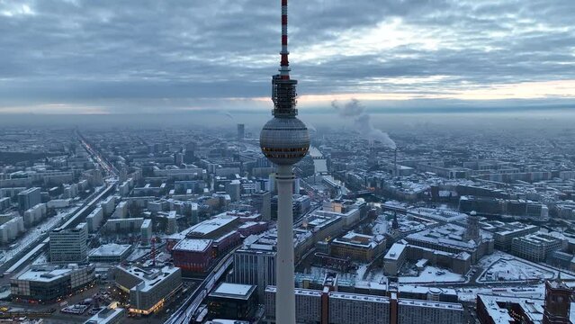City of Berlin, Germany from above. Aerial winter cityscape view at sunrise or sunset, showing architectural landmarks Oberbaum Bridge, TV Tower and Berlin Cathedral in winter. 