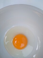 Raw eggs, top view of two raw eggs yolk in bowl on isolated white background.