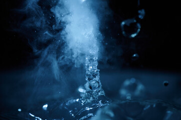 The process of boiling water, a stream of water shooting out of a humidifier or diffuser taken in...