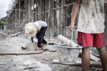 Concept of child labor, poor children being victims of construction labor, human trafficking, child...