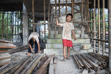 Concept of child labor, poor children being victims of construction labor, human trafficking, child...
