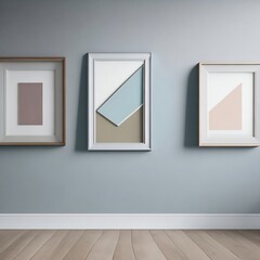 Three empty frames of different shapes and colors propped against a light grey wall in a room with a wood plank floor.

