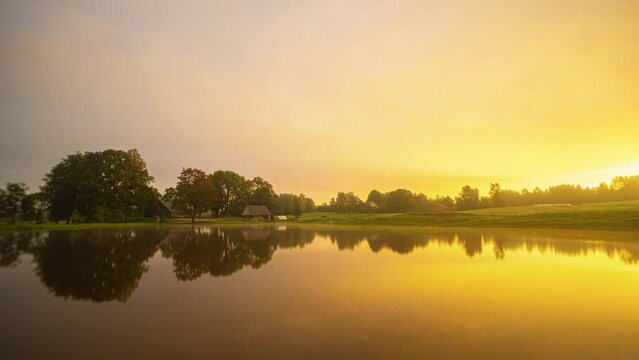Going from spring to summer, autumn and winter in a time lapse of a lake with a holiday home.