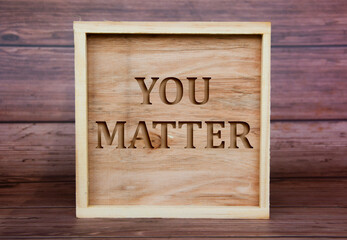 You matter text engraved on wooden frame. inspirational concept