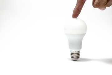 Finger touch on LED Light bulb on white background,Genius-Idea-intelligent-creativity-opportunity...