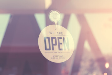 WE ARE OPEN - Open sign broad on a glass door at coffee shop (Filtered image processed vintage...