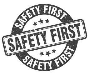 safety first stamp. safety first label. round grunge sign