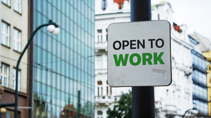 Open to work on a sign in a city business district