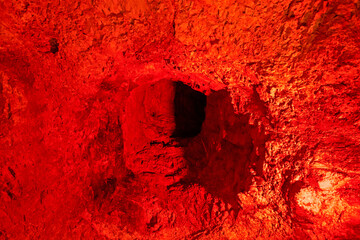 abstract background of red concrete surface with shell hole. War in Ukraine and Israel