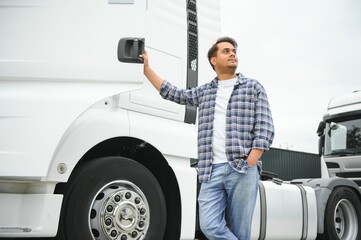 Portrait of confident indian truck driver on parking. Copy space
