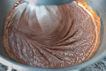 Brownie mix being blended by stand up mixer