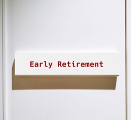 Sign on white door Early Retirement - refers to practice of retiring before reaching usual employer's official retirement age - stop working before 60