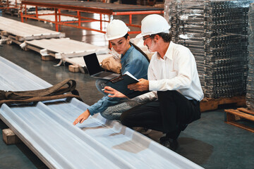 Fototapeta na wymiar Metalwork manufacturing factory manager inspect newly manufactured metal or steel sheets and frame in factory. Inspection and quality control process ensure highest quality product. Exemplifying