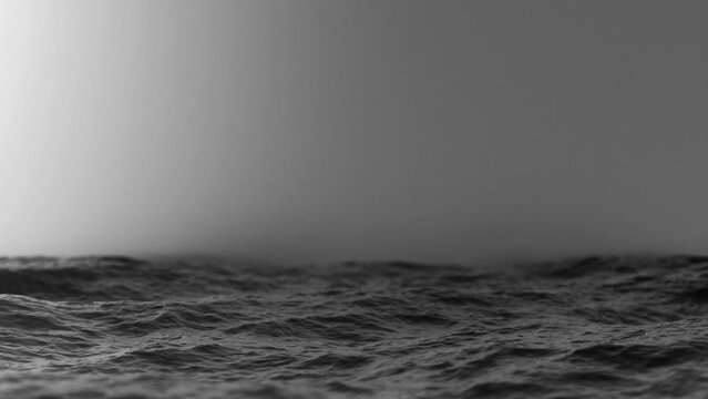 slow-motion view of the misty wavy ocean surface, dramatic black and white, 4k seamless loop