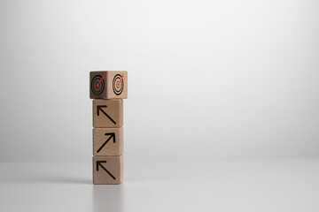 Concept of Sustainable business strategy planning for future financial success. Wood cube block stacking with icon. Achieving business goals with a sound strategy. Corporate growth and achievement.