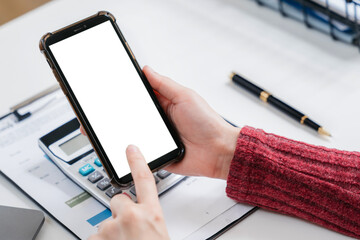 Business - technology and office concept - Hand holding mobile phone with blank screen in office.