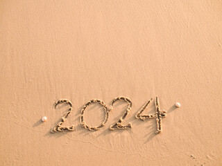 2024 year written on the beach in the sunset time. New Year 2024 concept