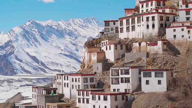 Closeup shot of Key Monastery with snow covered Himalayan mountain peaks in the background during the winter season at Key Monastery near Kaza in Spiti Valley, Himachal Pradesh, India. Spiti in winter