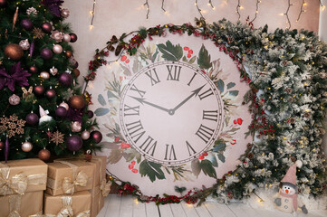 Gorgeous Christmas and New Year decor featuring Christmas clock decorated with snowy tree branches and other Christmas decorations: Christmas tree, snowman, gifts