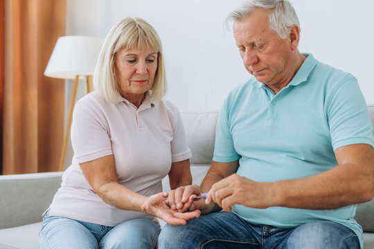 Senior couple use blood glucose meter and worry about it