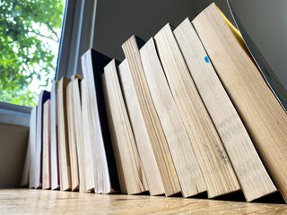 Old Books Stacked on wooden table in Natural Light - Powered by Adobe