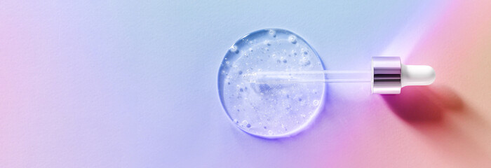 pipette drops of serum on pastel multicolored background