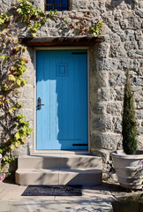 old stone building with a vintage blue door
