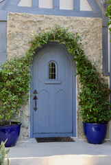 vintage stone building from the 1930s with arched blue door