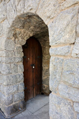 Fototapeta na wymiar ancient cellar door to a century old clock tower