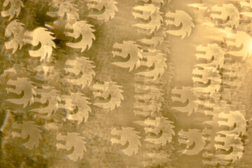 Golden yellow holiday bokeh in dragon head shape. Abstract Christmas and Chinese New Year background