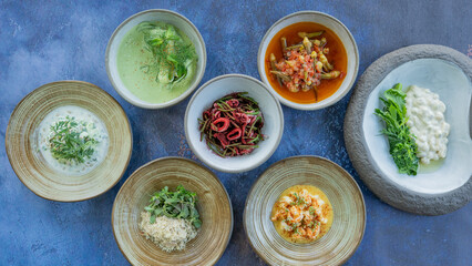 Traditional Turkish and Greek dinner meze table. Turkish Cuisine Cold Appetizers (appetizers with olive oil). Turkish appetizers in colorful plates. yogurt and various boiled herbs
