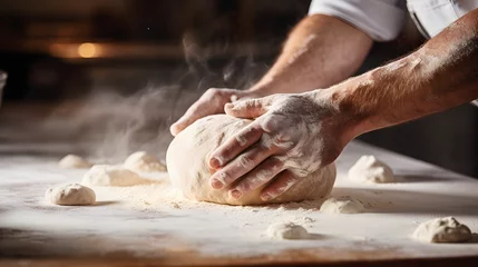 Foto auf Acrylglas Bäckerei A chefs hands kneading dough for artisan bread in a bakery kitchen.